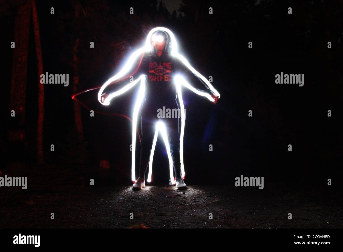 Teenagers Drawing With Light Late At Night, Outline Human Form Stock Photo