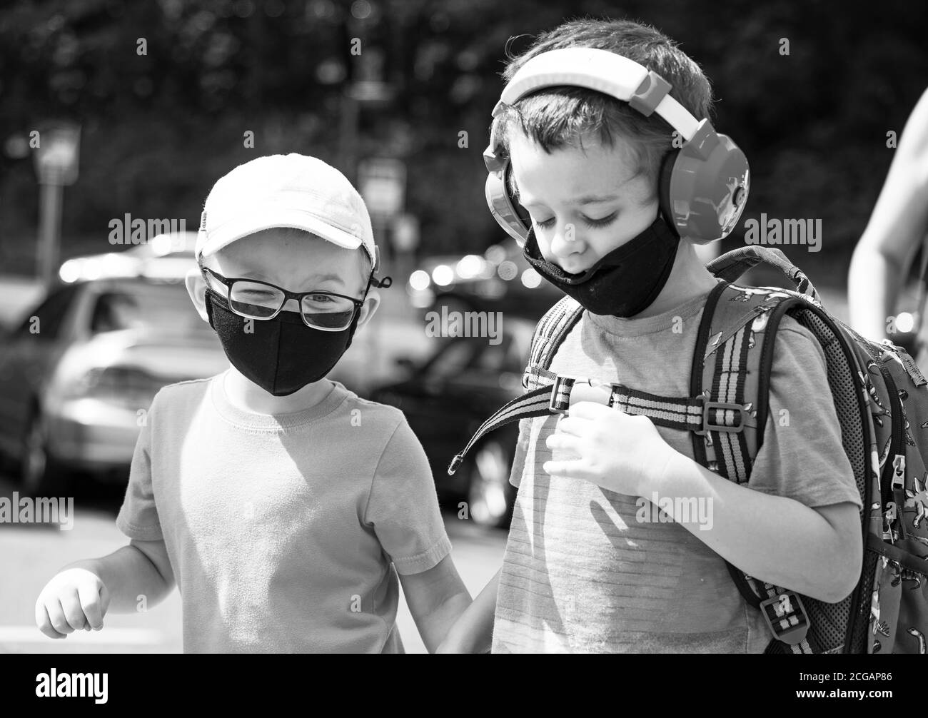 two 4 year old children first day back to school, facial mask wearing Stock Photo