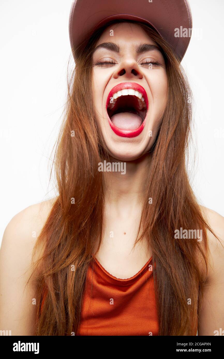 Portrait of a woman in a cap Mouth wide open model eyes closed attractive  look Stock Photo - Alamy