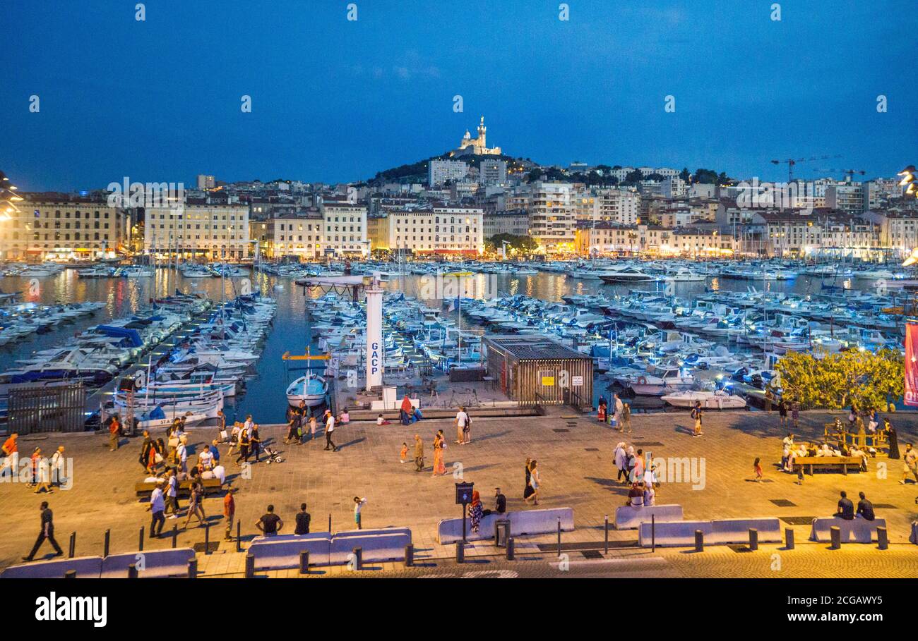 evening view of Vieux Port, the Old Port of Marseille with Basilique Notre-Dame de la Garde in the background on the highest natural point in Marseill Stock Photo
