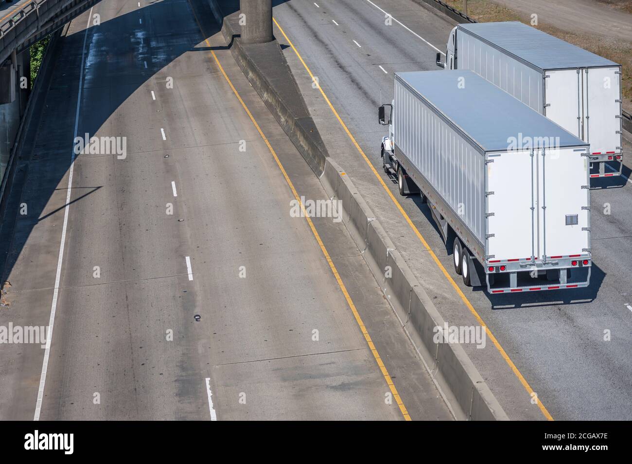 Two different classic industrial long haul diesel big rigs semi trucks ...