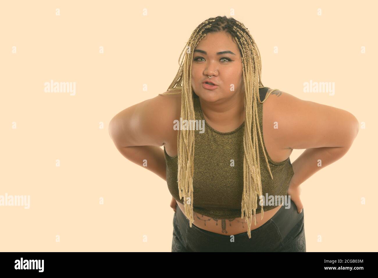 Studio shot of young fat Asian woman puckering lips while bending forward  Stock Photo - Alamy