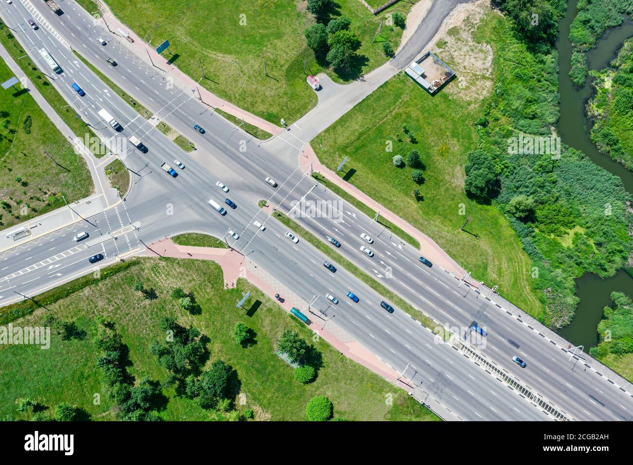 aerial drone view of suburban street intersection with car traffic in sunny day Stock Photo