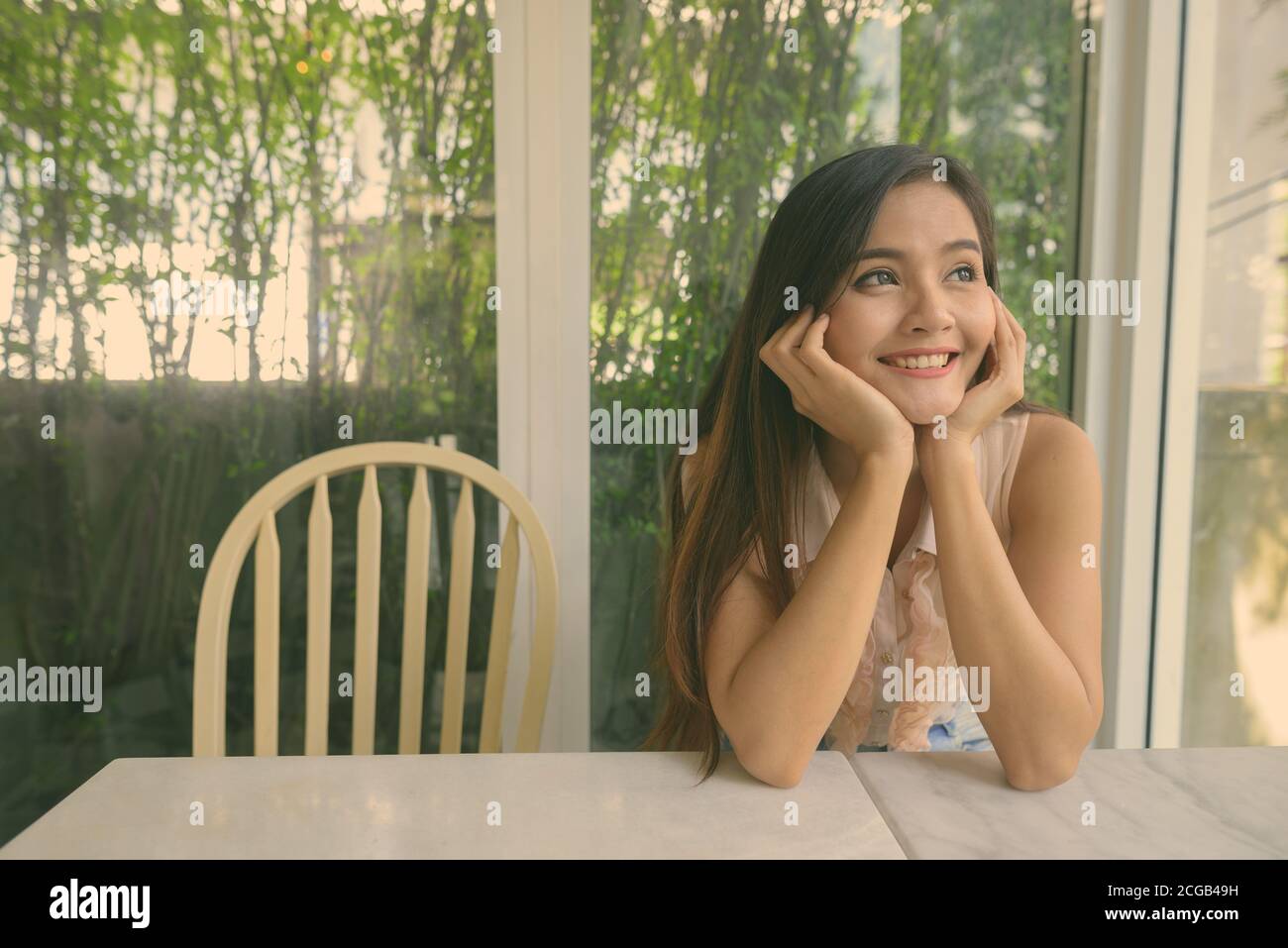 Young beautiful Asian woman relaxing at the coffee shop Stock Photo - Alamy