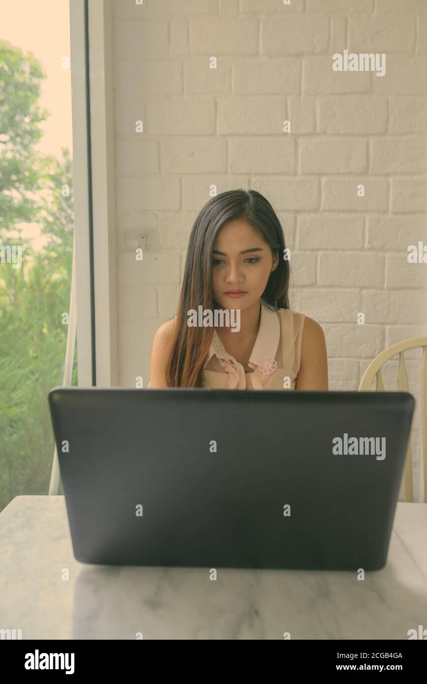 Young beautiful Asian woman relaxing at the coffee shop Stock Photo - Alamy