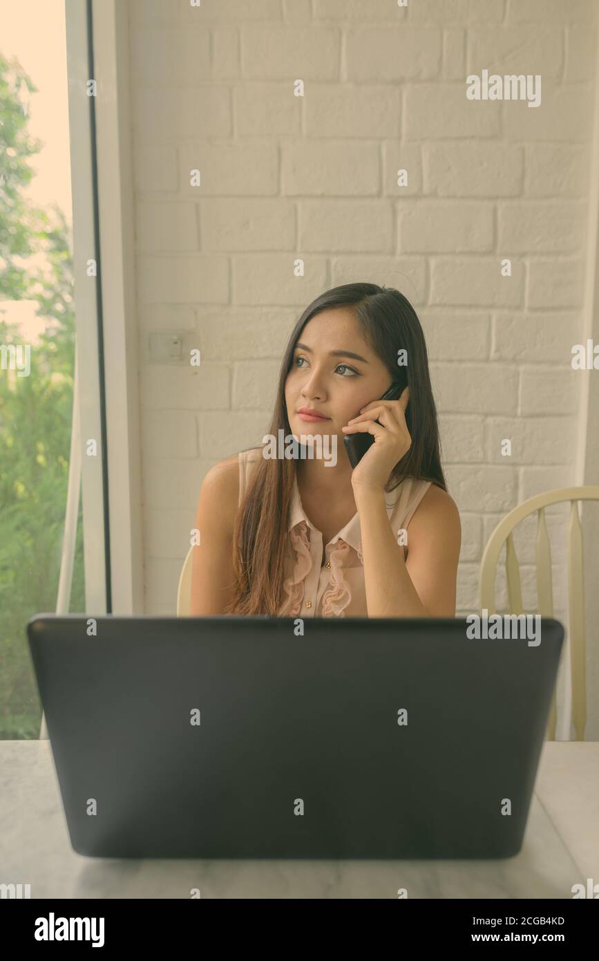 Young beautiful Asian woman relaxing at the coffee shop Stock Photo - Alamy