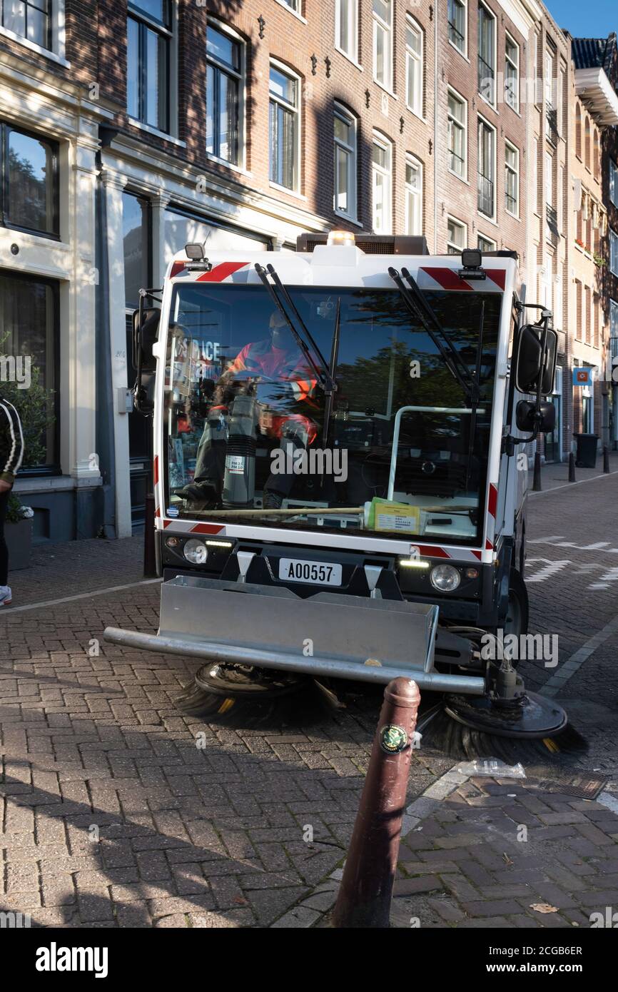 Sweeping cleaning vehicle cleaning a gracht in Amsterdam, the