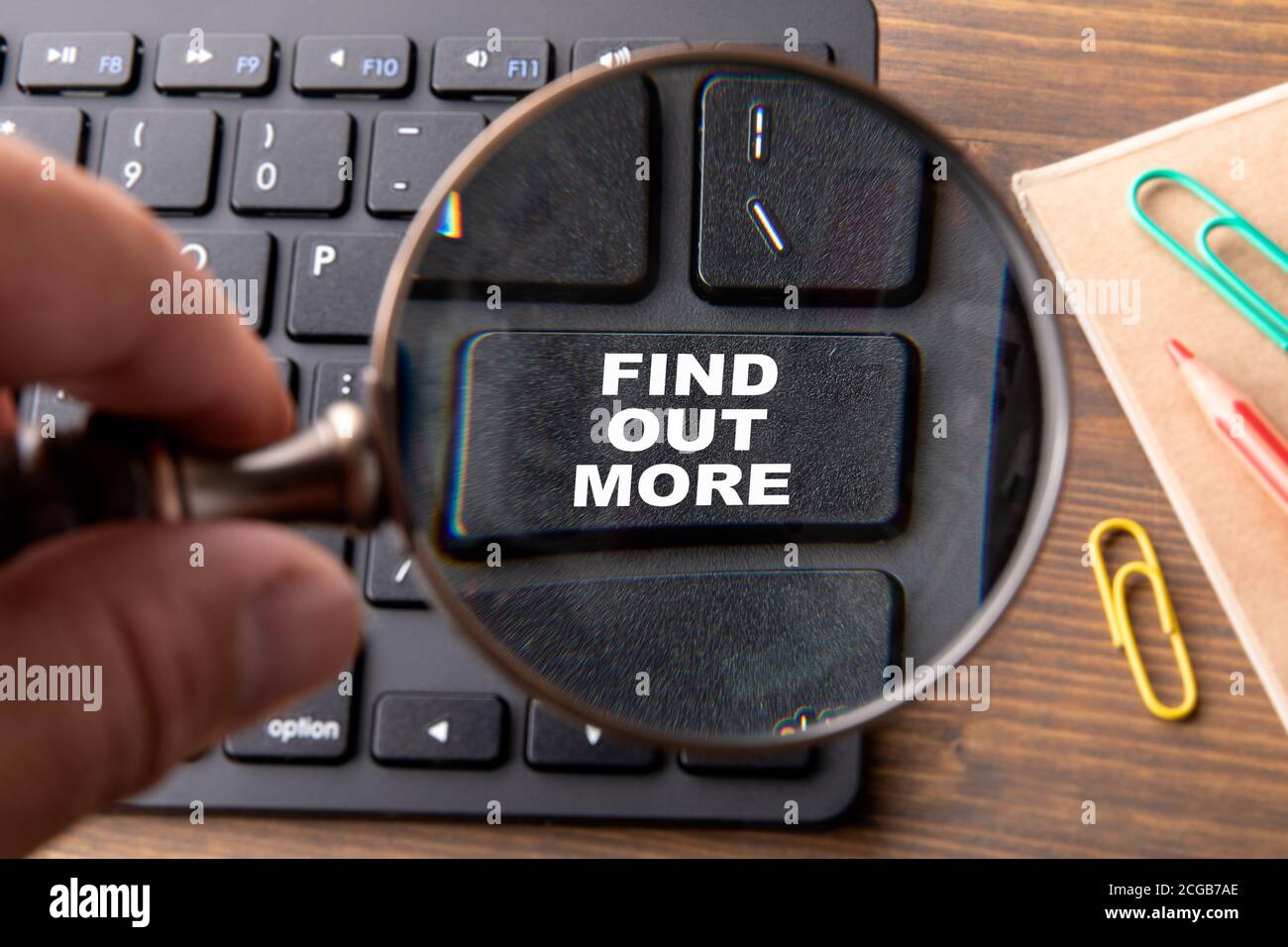 FIND OUT MORE. Computer keyboard on a wooden table. Stock Photo