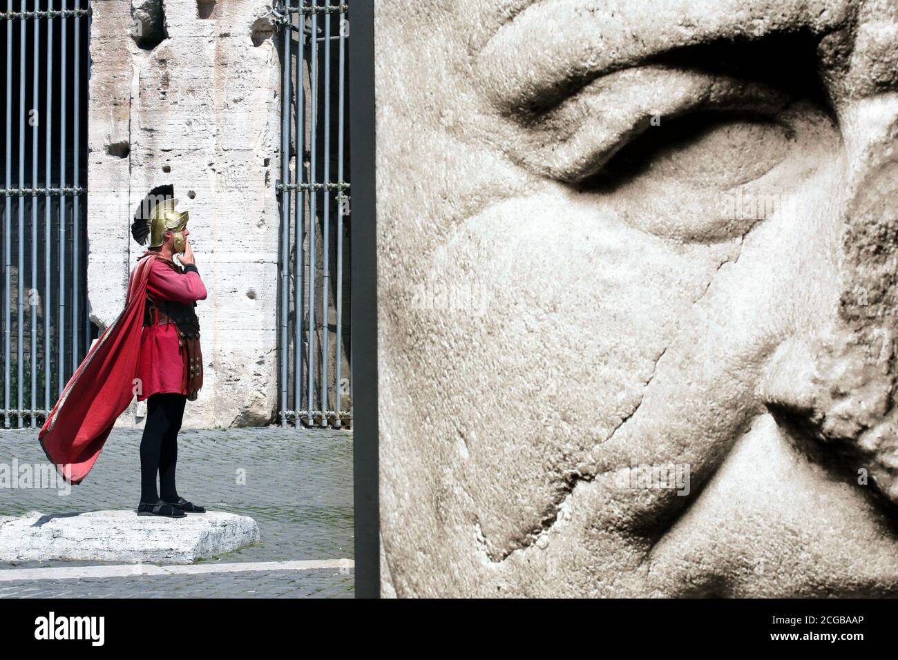 ROME - A gladiator at the colloseum near an image of Titus Vespianus Stock Photo