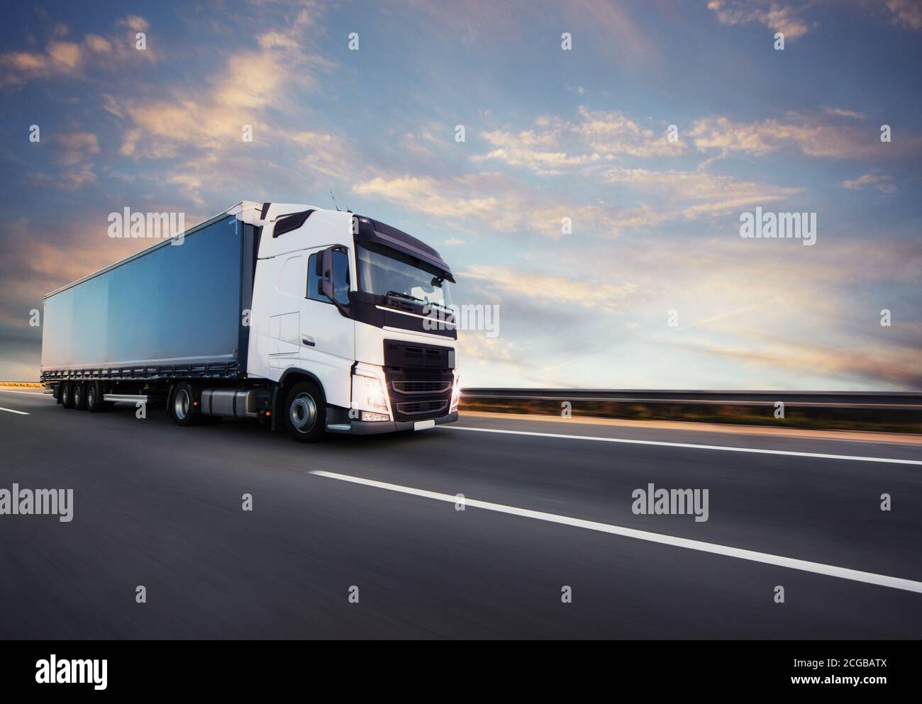 European truck vehicle on motorway with dramatic sunset light. Cargo ...