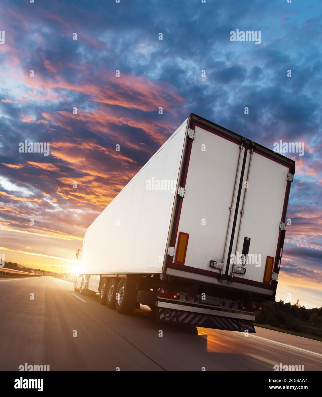 Backview of european truck vehicle on motorway with dramatic sunset ...