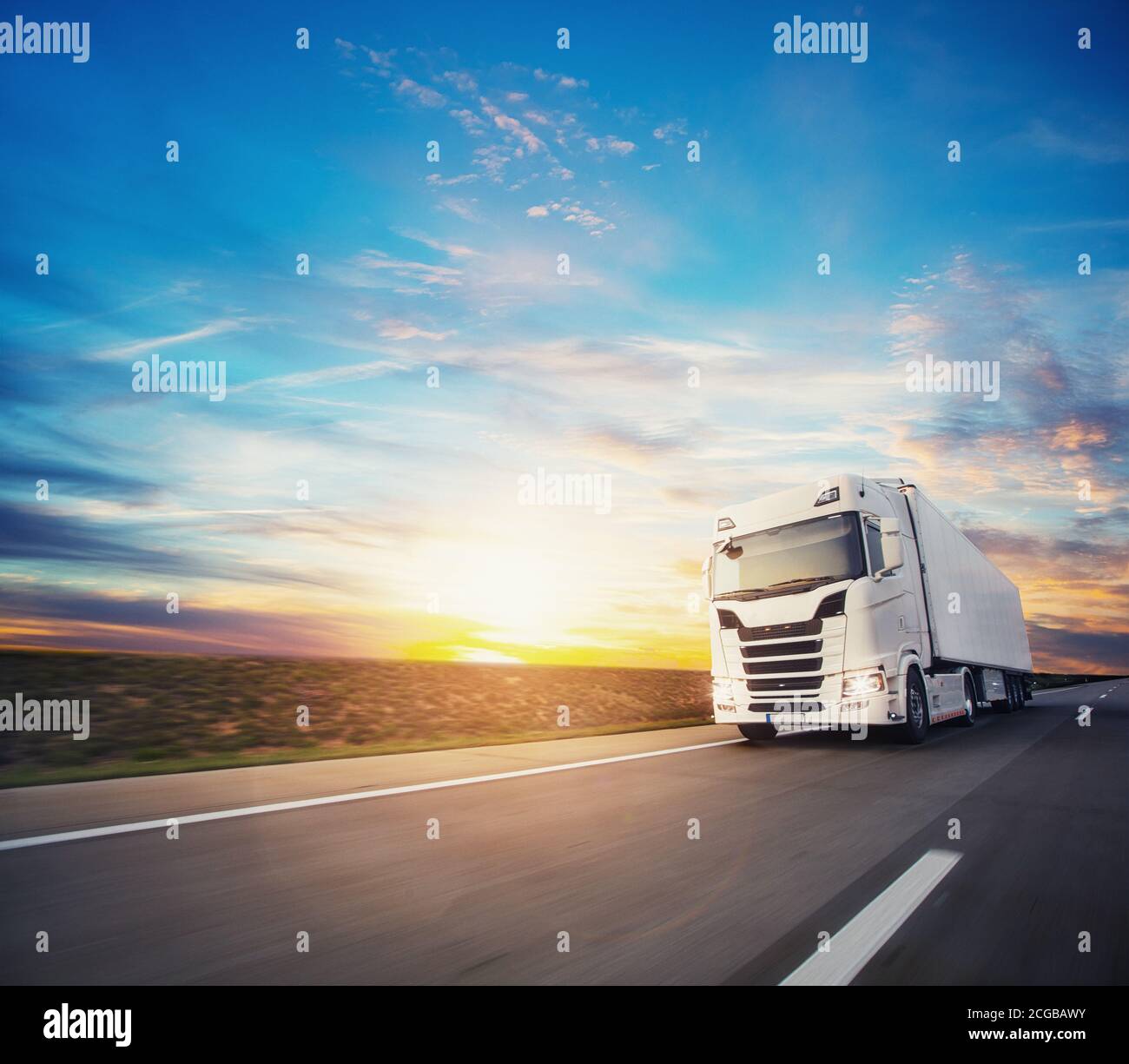 European truck vehicle on motorway with dramatic sunset light. Cargo ...