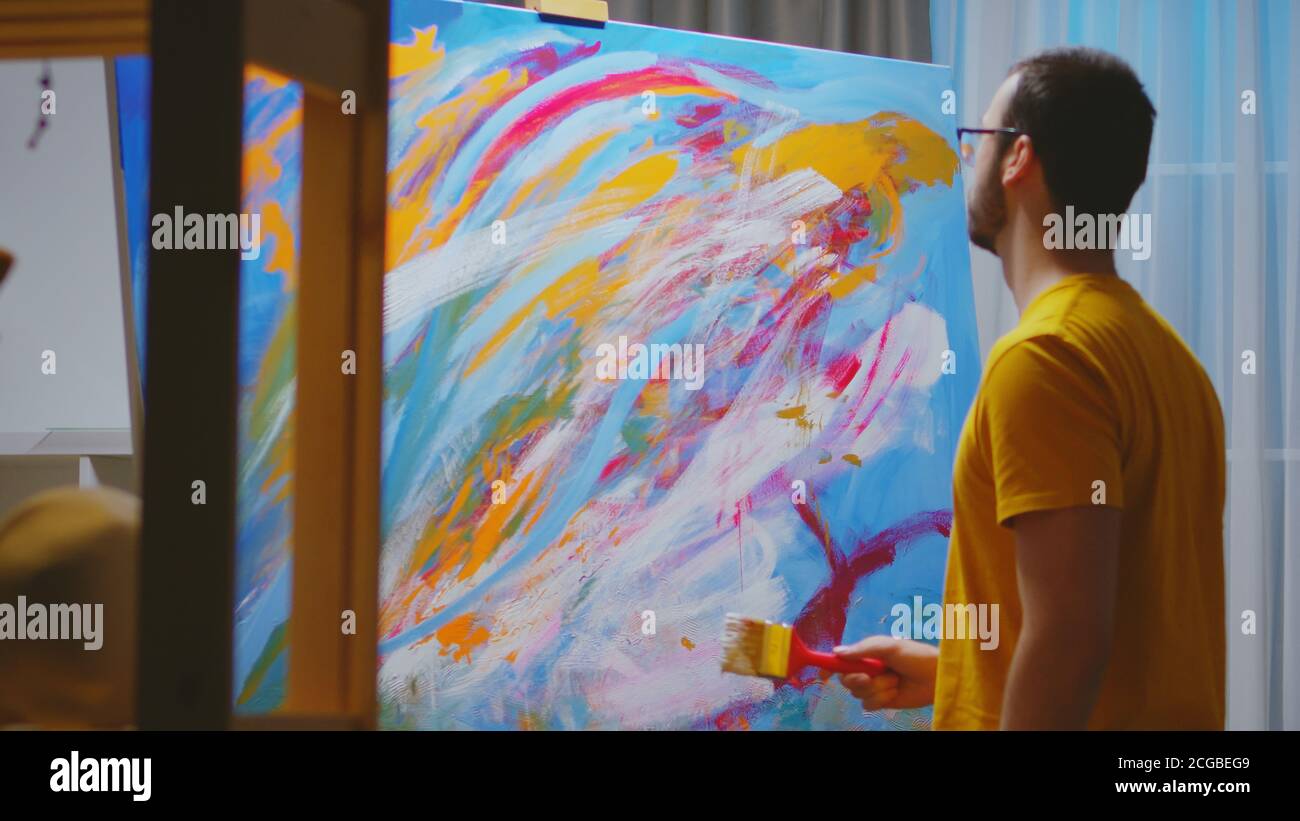 Successful painter working on oil painting in art Stock Photo