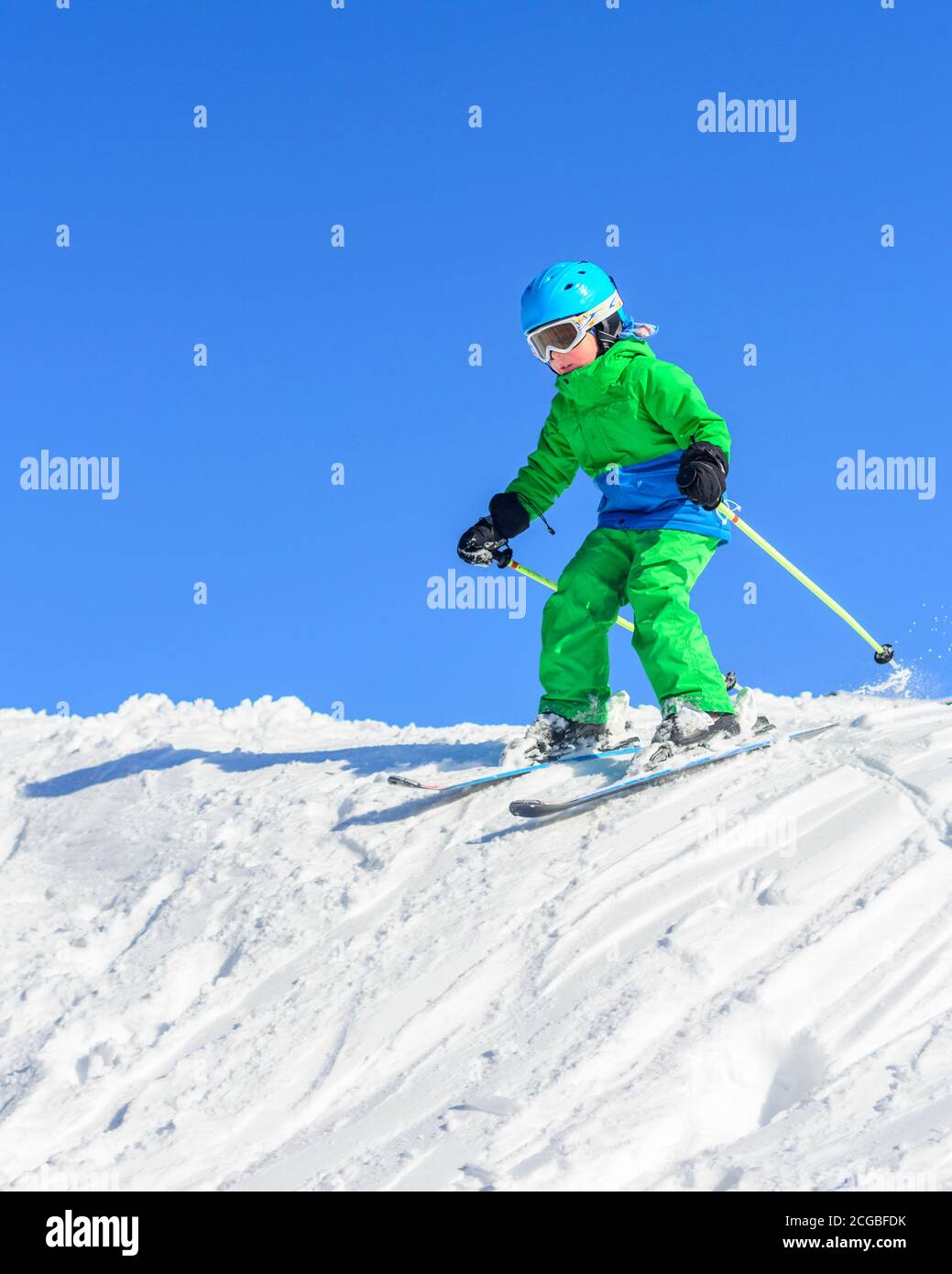 Little skiers learn to ski on a well-prepared slope and have a lot of fun. Stock Photo