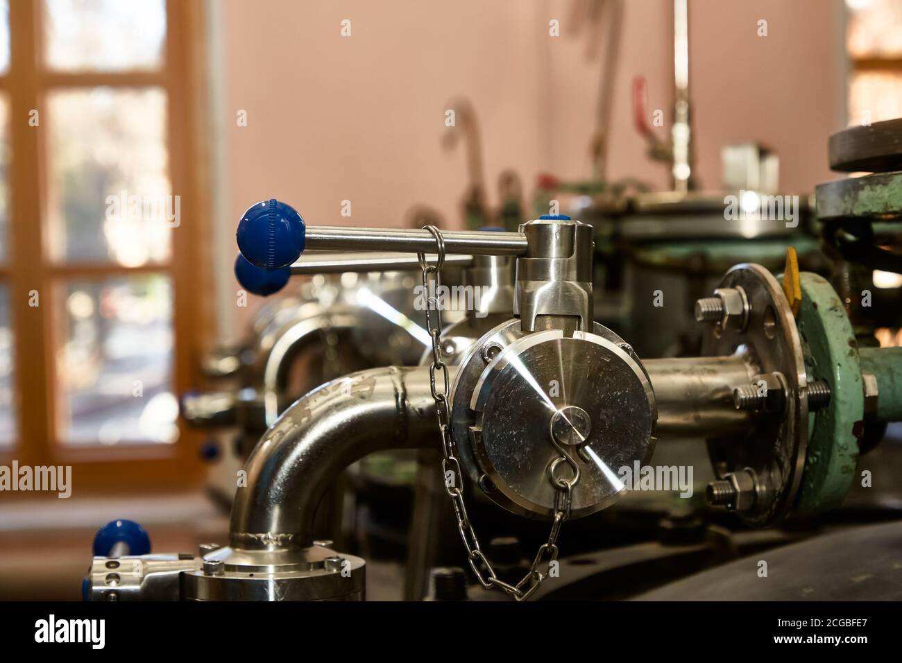Pipelines and valves, a fragment of some food or chemical production. Stock Photo