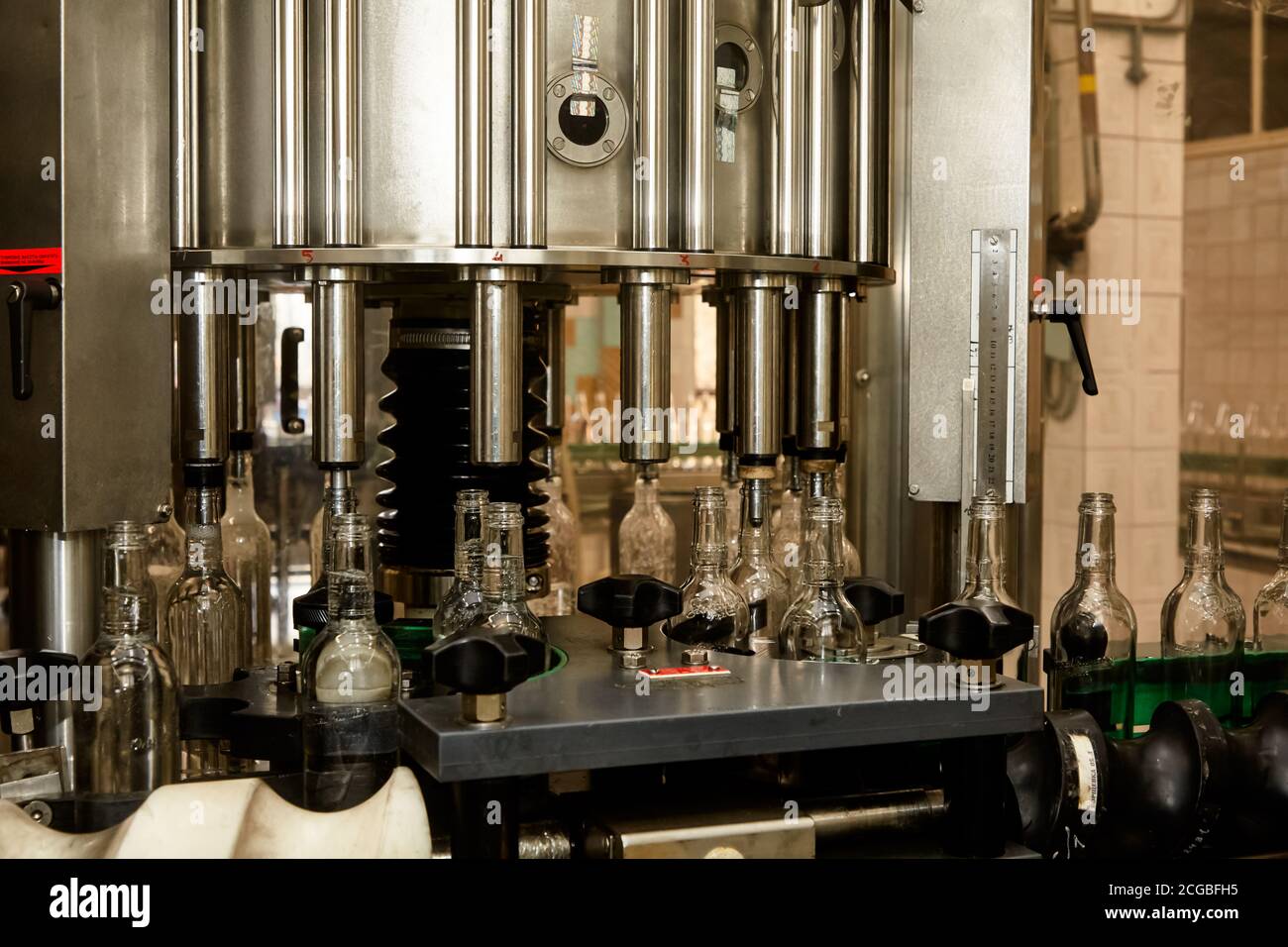 Factory for the production of alcoholic beverages. On the conveyor ...