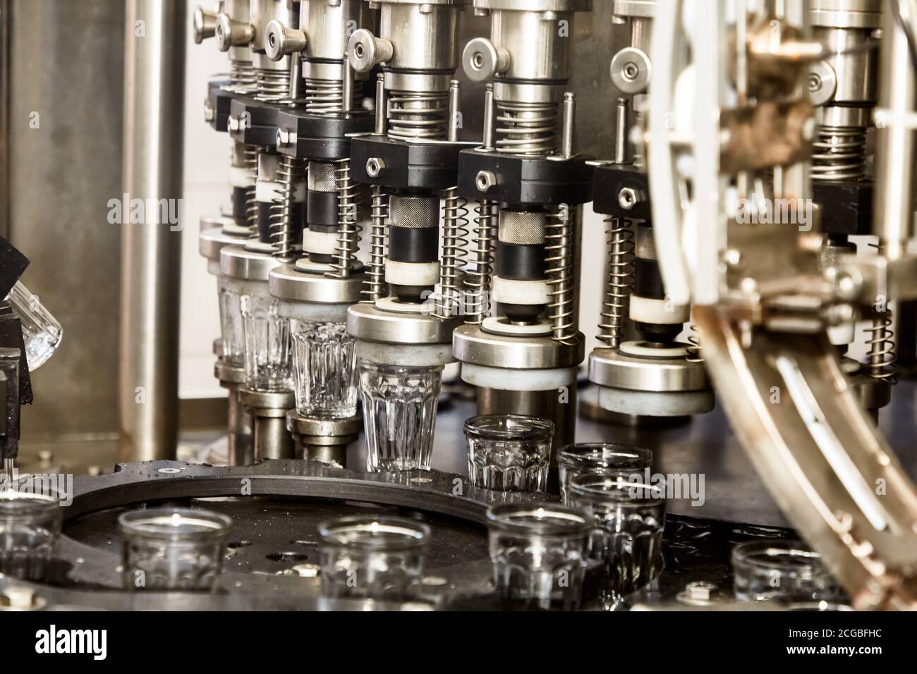 Factory for the production of alcoholic beverages. On the conveyor, vodka is bottled. Stock Photo