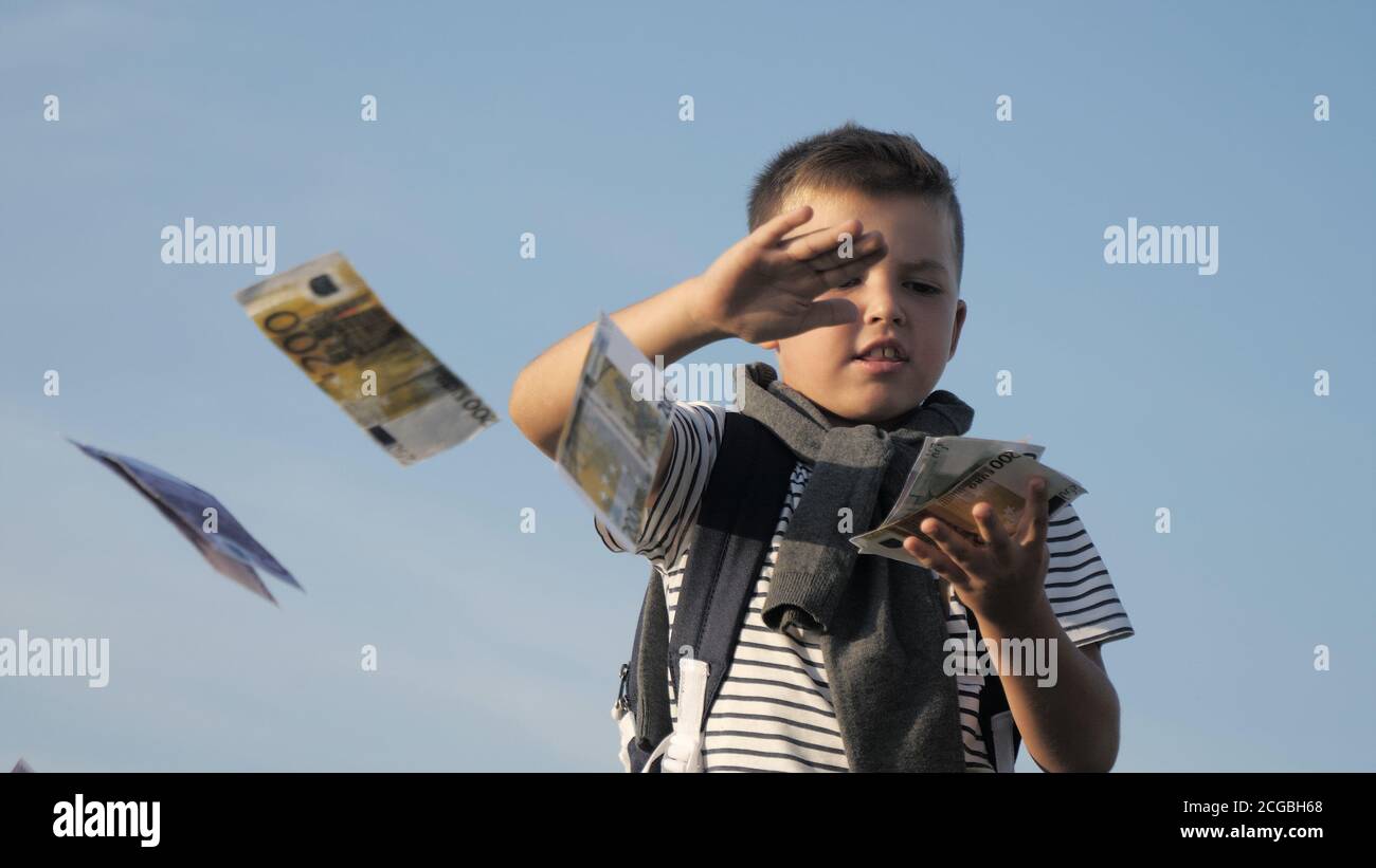 Boy throws money into the air Stock Photo Alamy