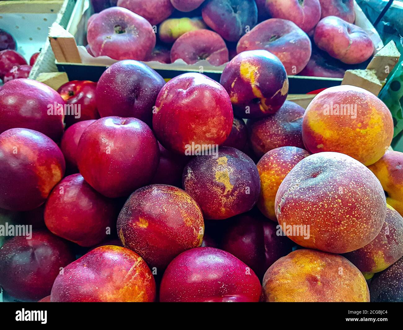 Fresh plums are in a drawer in the store Stock Photo Alamy