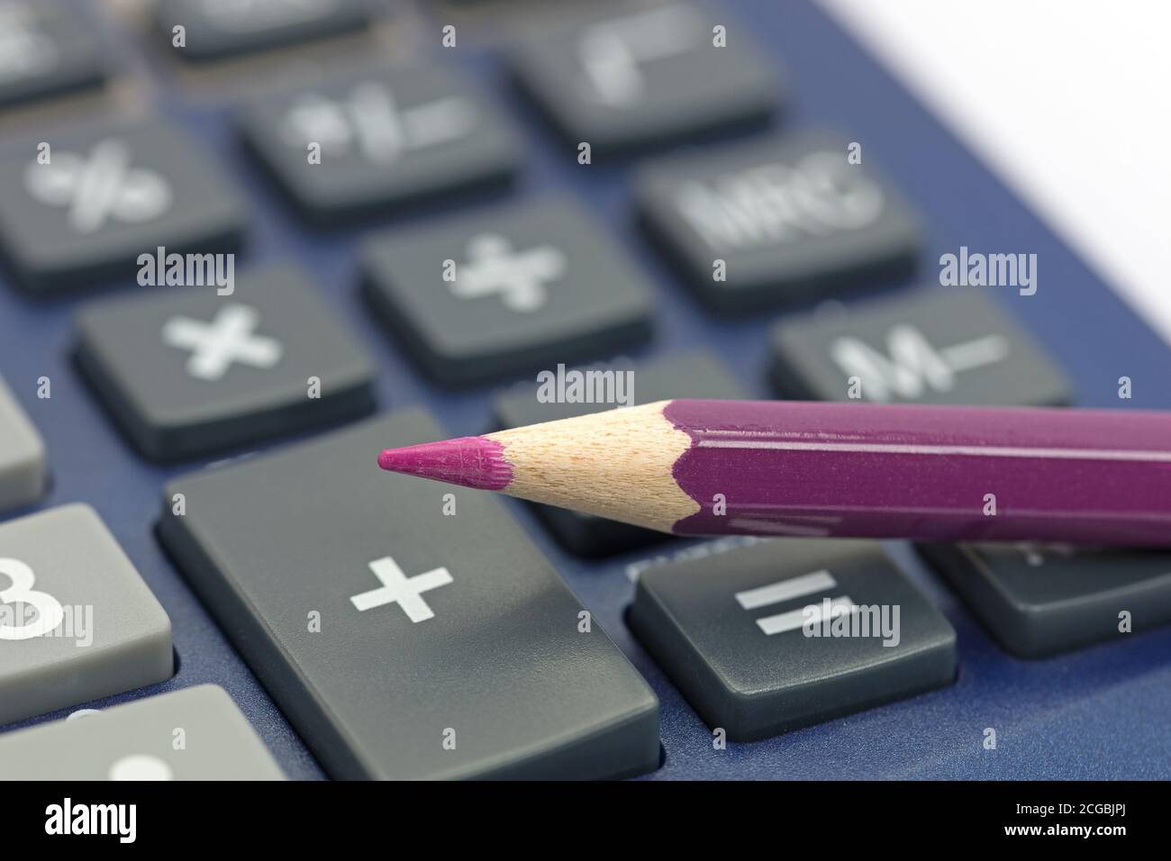 Red pen on a calculator Stock Photo