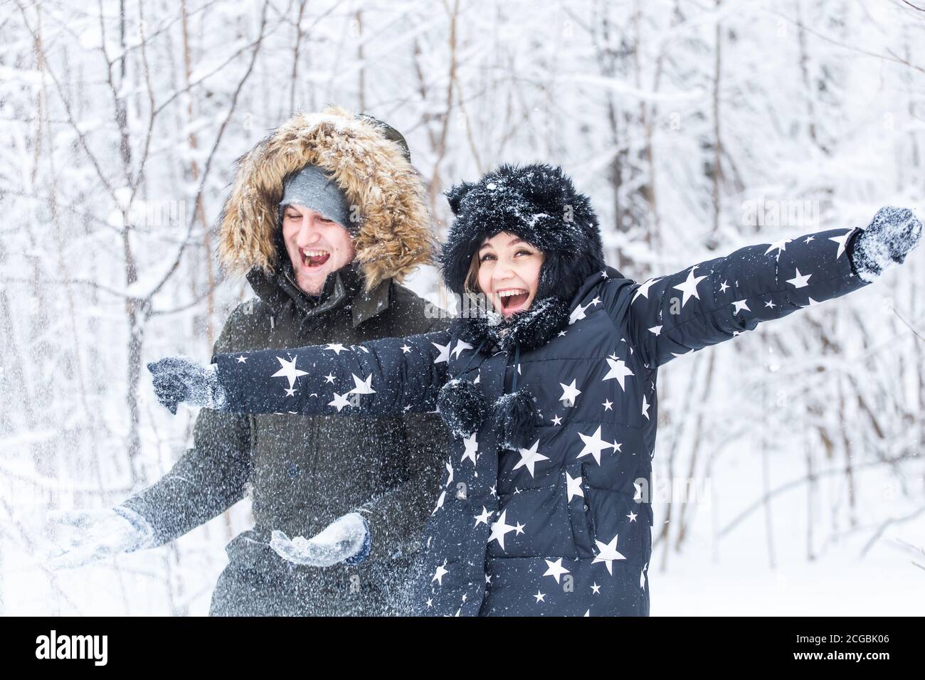 Young couple playing with snow in winter park Stock Photo - Alamy