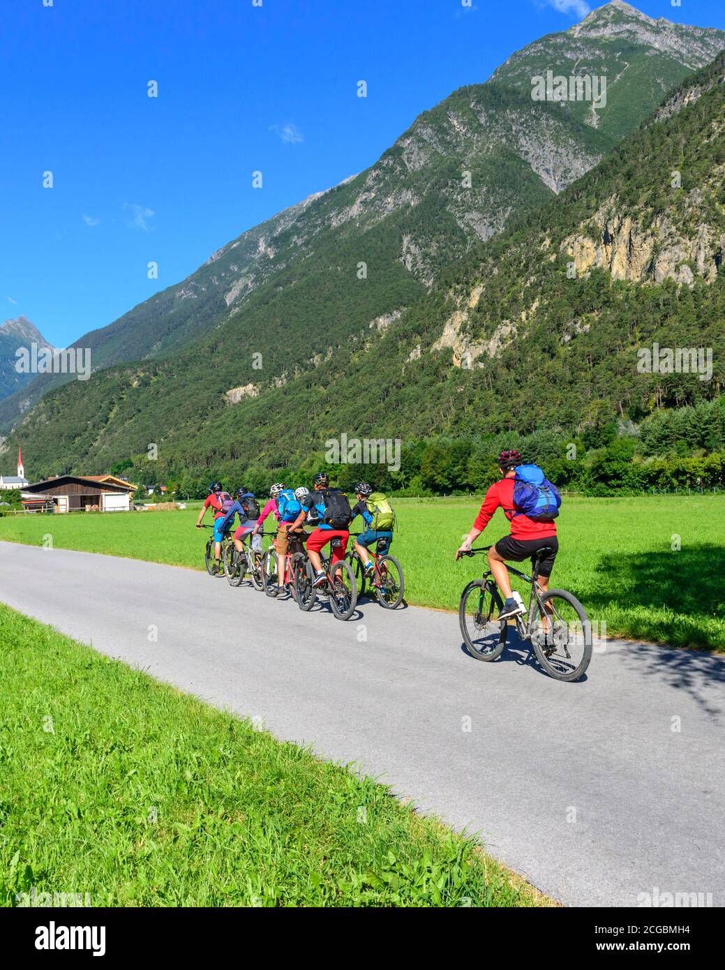 Mountainbikers cycling in Inn valley between Imst and Landeck Stock Photo