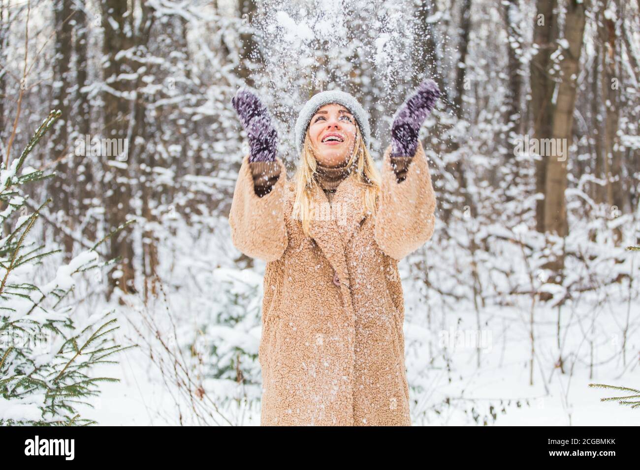Woman throws up snow, fun and winter concept Stock Photo Alamy