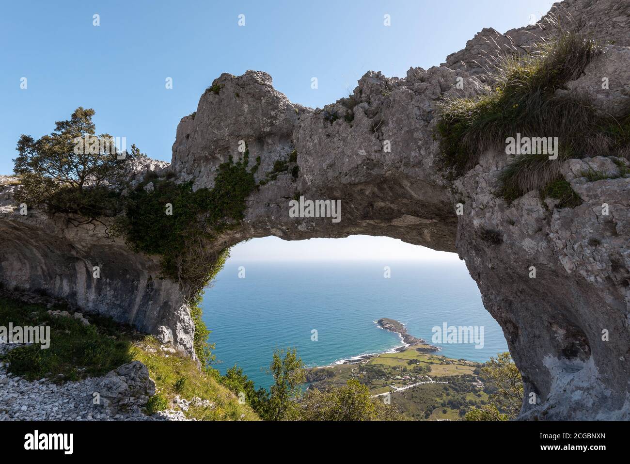 Natural arch called Ojo del Diablo (Eye of the Devil) in Cantabria, Spain Stock Photo