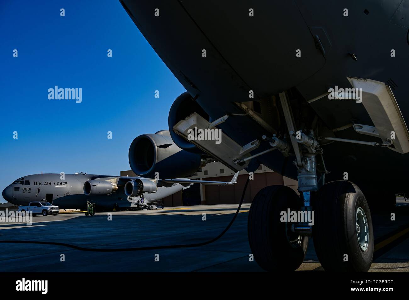 Airmen assigned to the 911th Maintenance Squadron service a C-17 ...