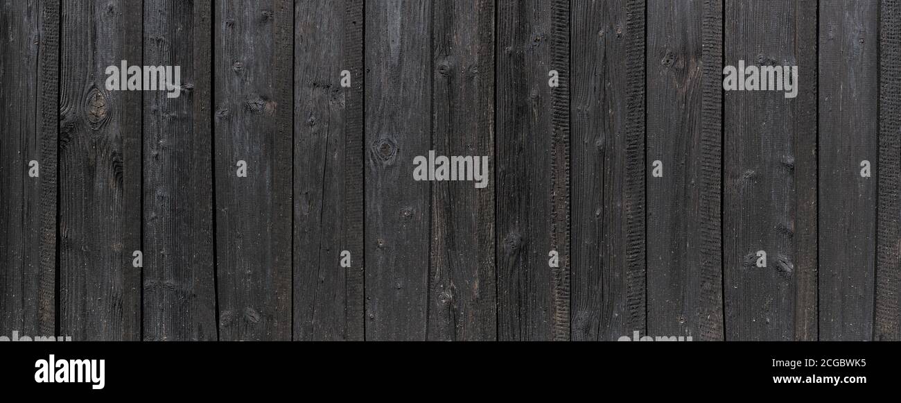 Panoramic detail of an old black wooden wall Stock Photo