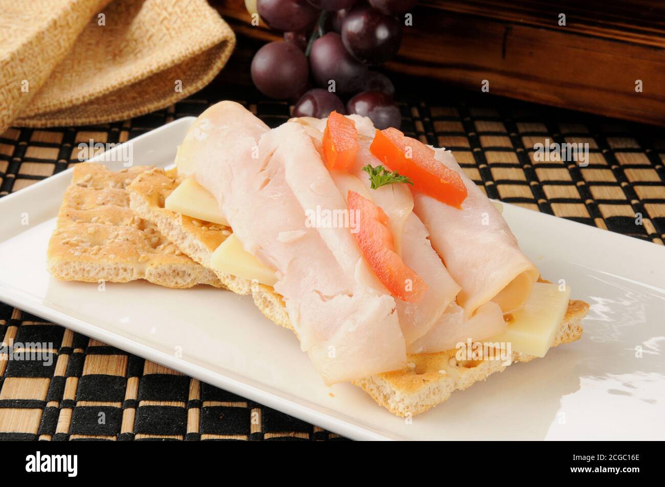 Ham and swiss sandwich on sesame flatbread crackers Stock Photo Alamy