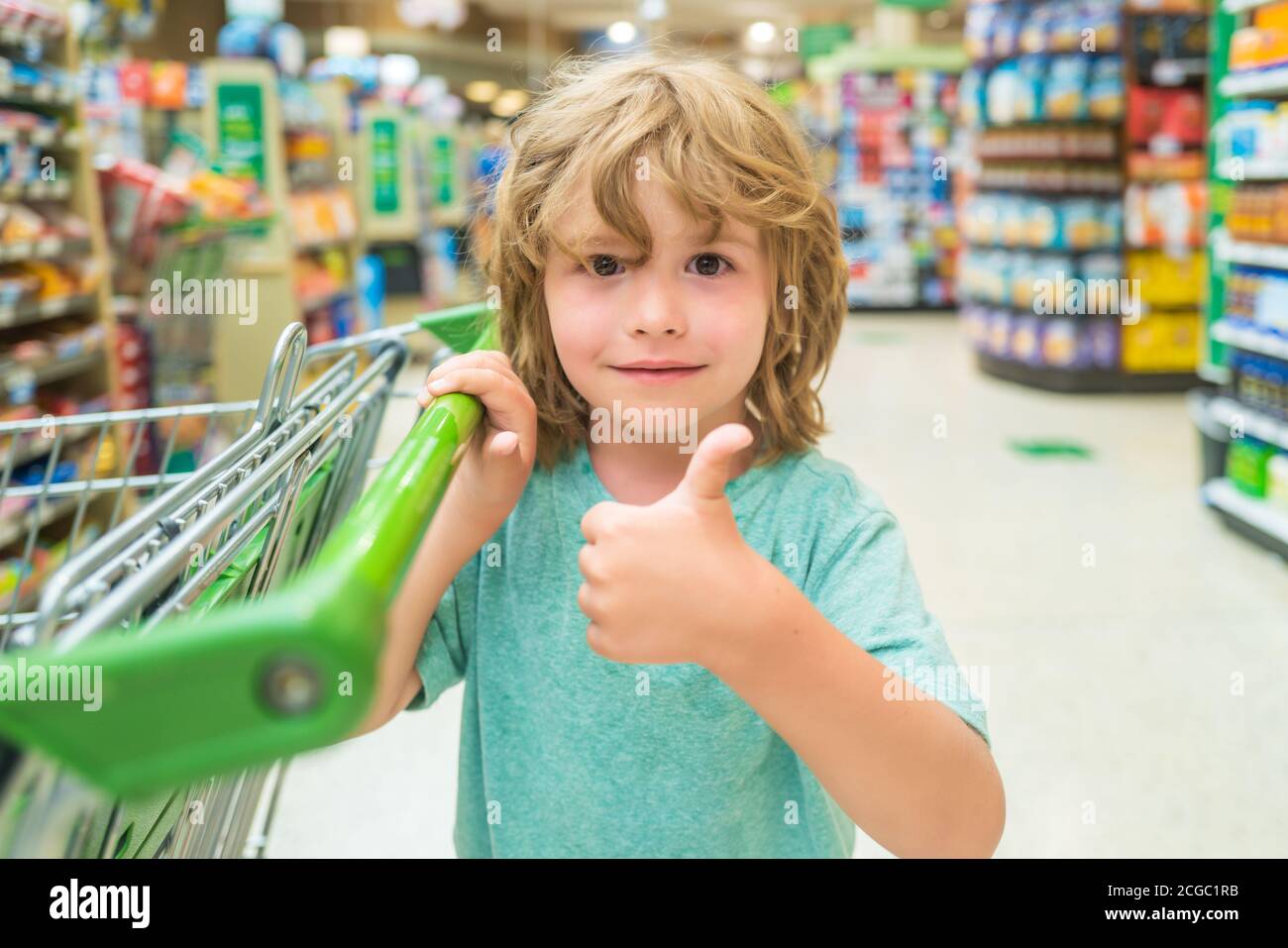 Boy with a grocery cart. Child in supermarket. Concept of shopping