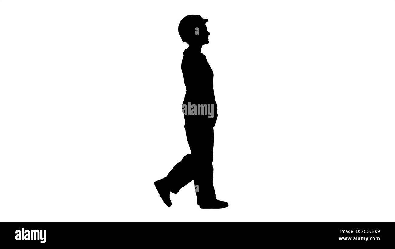 Silhouette Woman builder walking with hands in pockets. Stock Photo