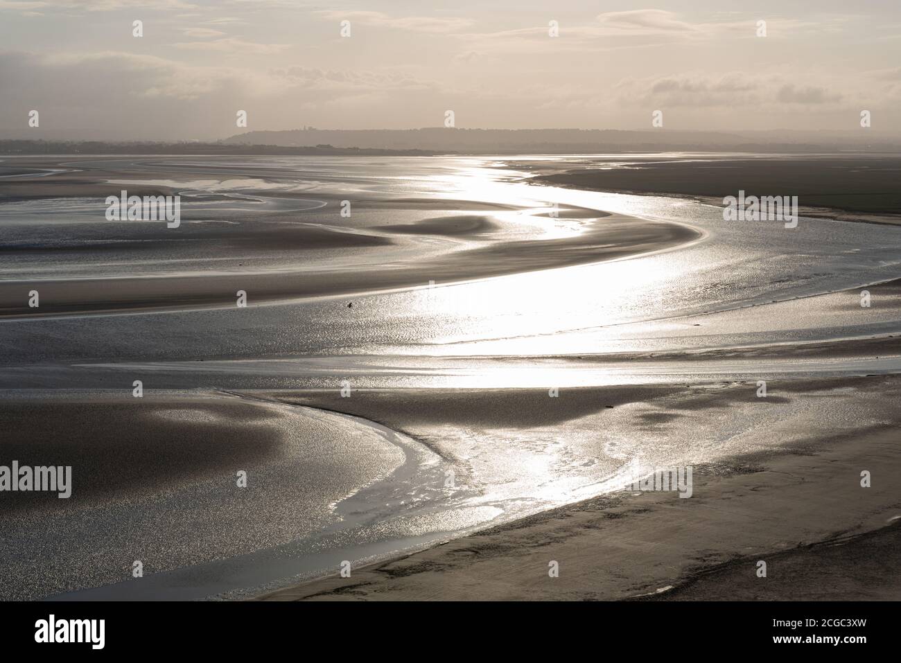 early morning from Mont Saint Michel with low tide and Couesnon river canal, Mont Saint Michel, Brittany, France Stock Photo