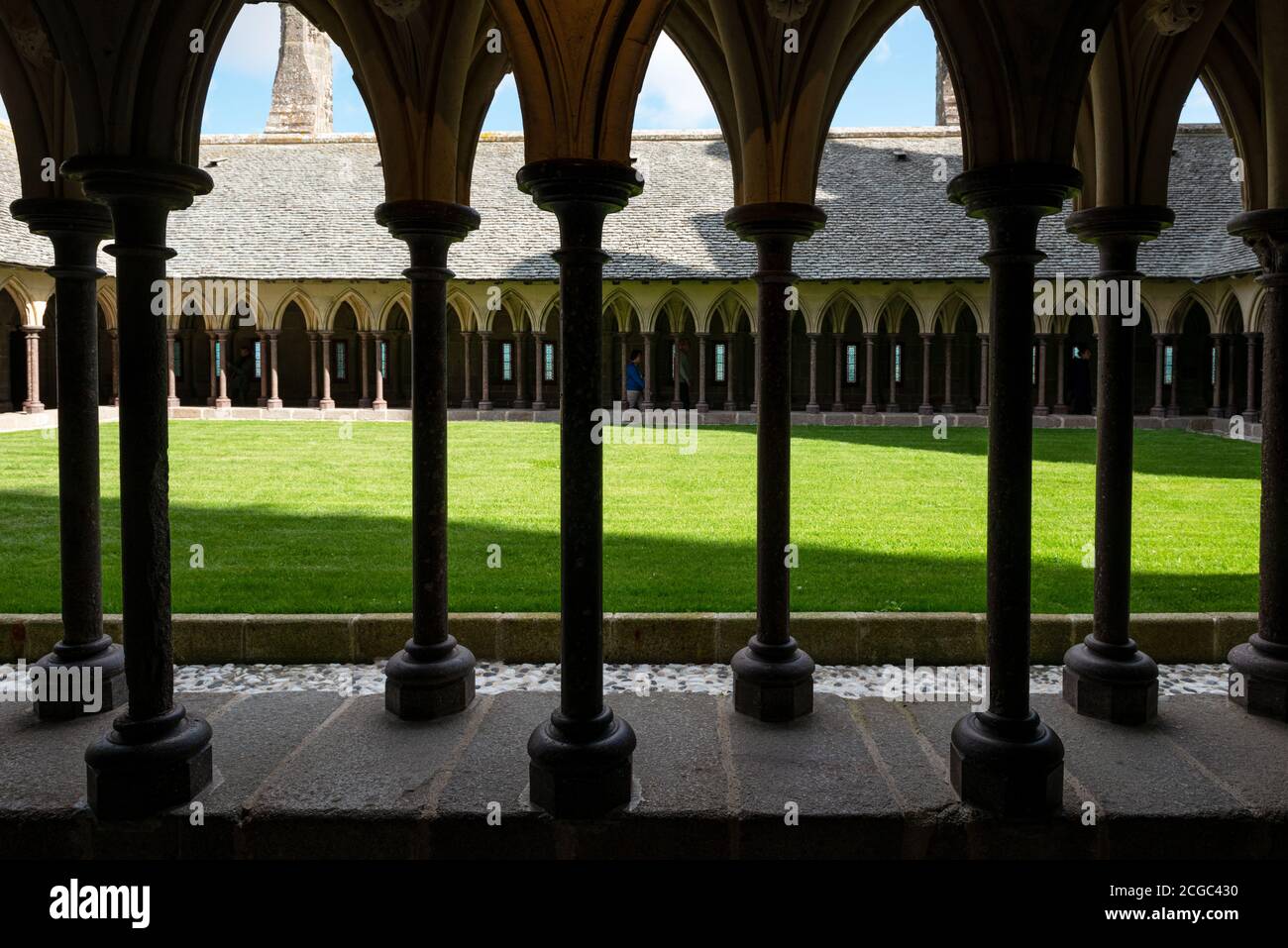 the Cloister of Mont Saint Michel with ribbed vault, pillars and lawn, Brittany, France Stock Photo