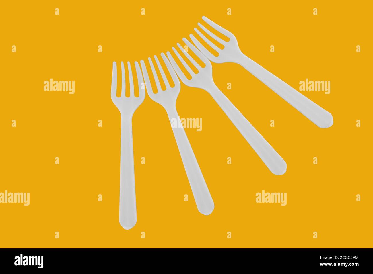 four plastic white forks on background Stock Photo