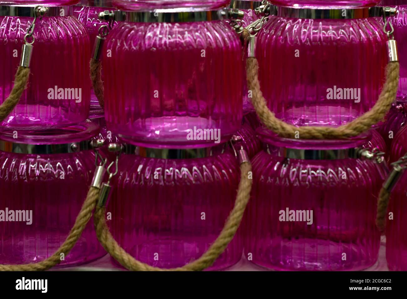 Pink glass jars with a handle. In A row Stock Photo Alamy