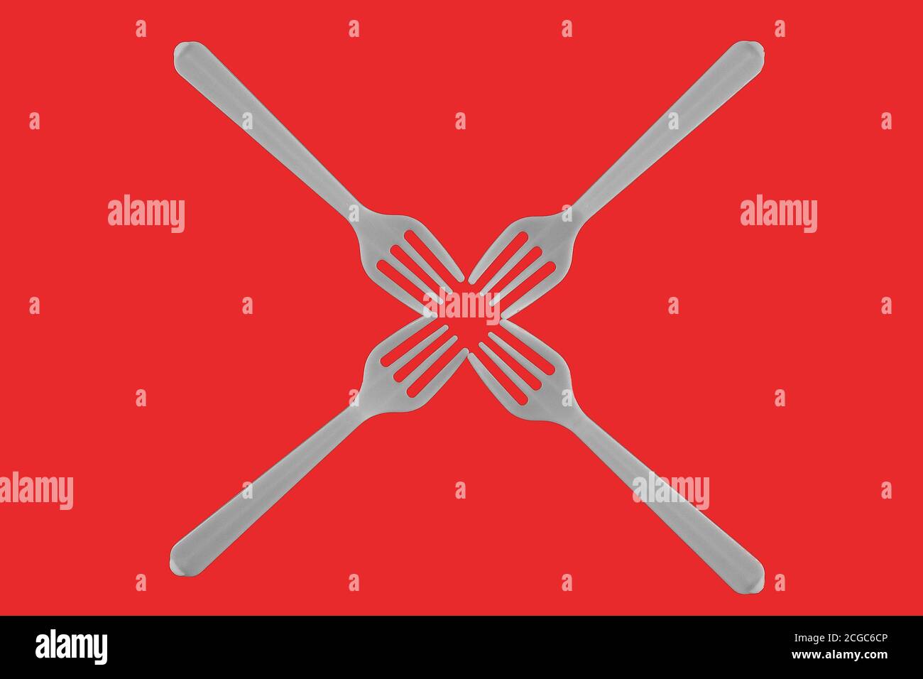 four plastic white forks on a red background Stock Photo