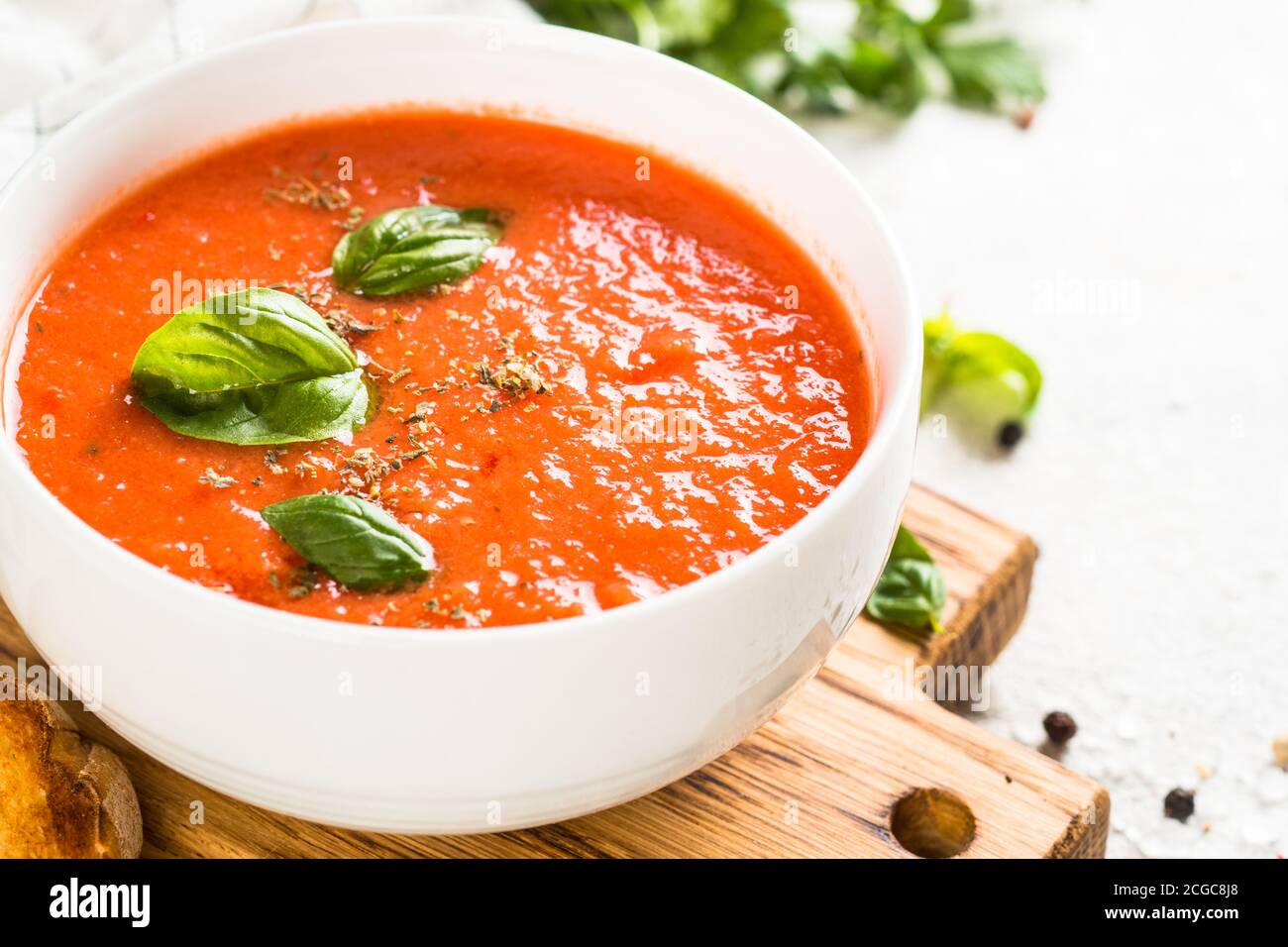 Tomato soup at white table Stock Photo - Alamy
