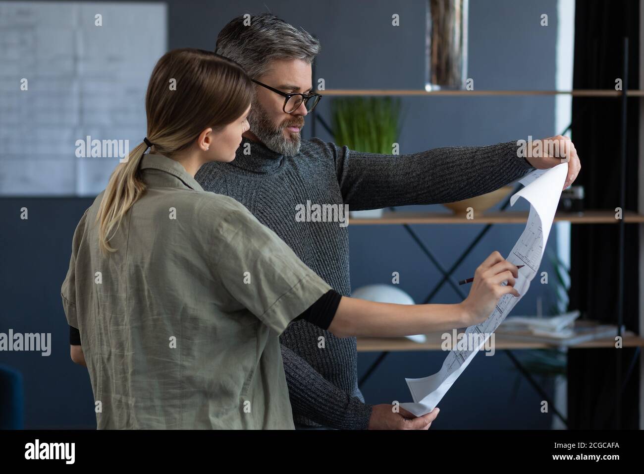 Engineer team working in office with blueprints and architect equipment ...
