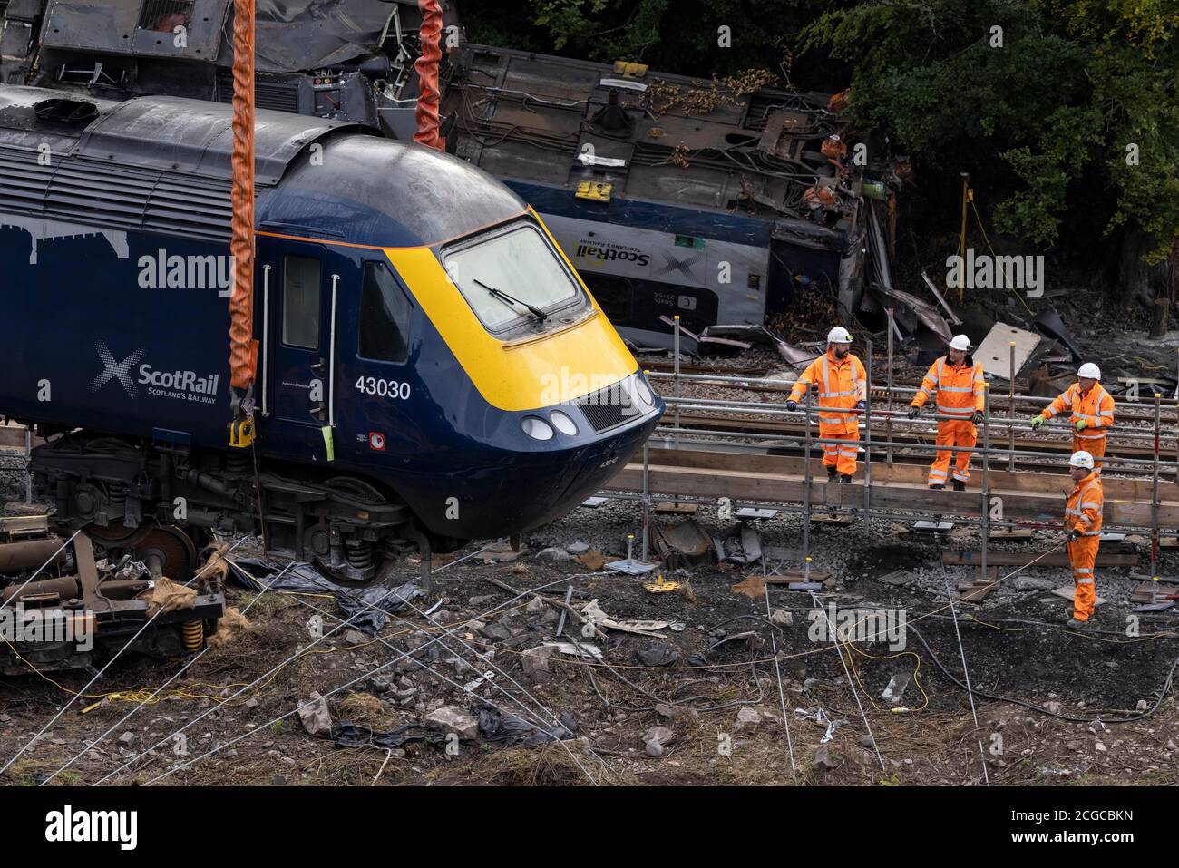 A carriage is lifted by crane from the site of the Stonehaven rail crash as work continues at the scene in Aberdeenshire, following the derailment of the ScotRail train which cost the lives of three people on Wednesday August 12. Stock Photo