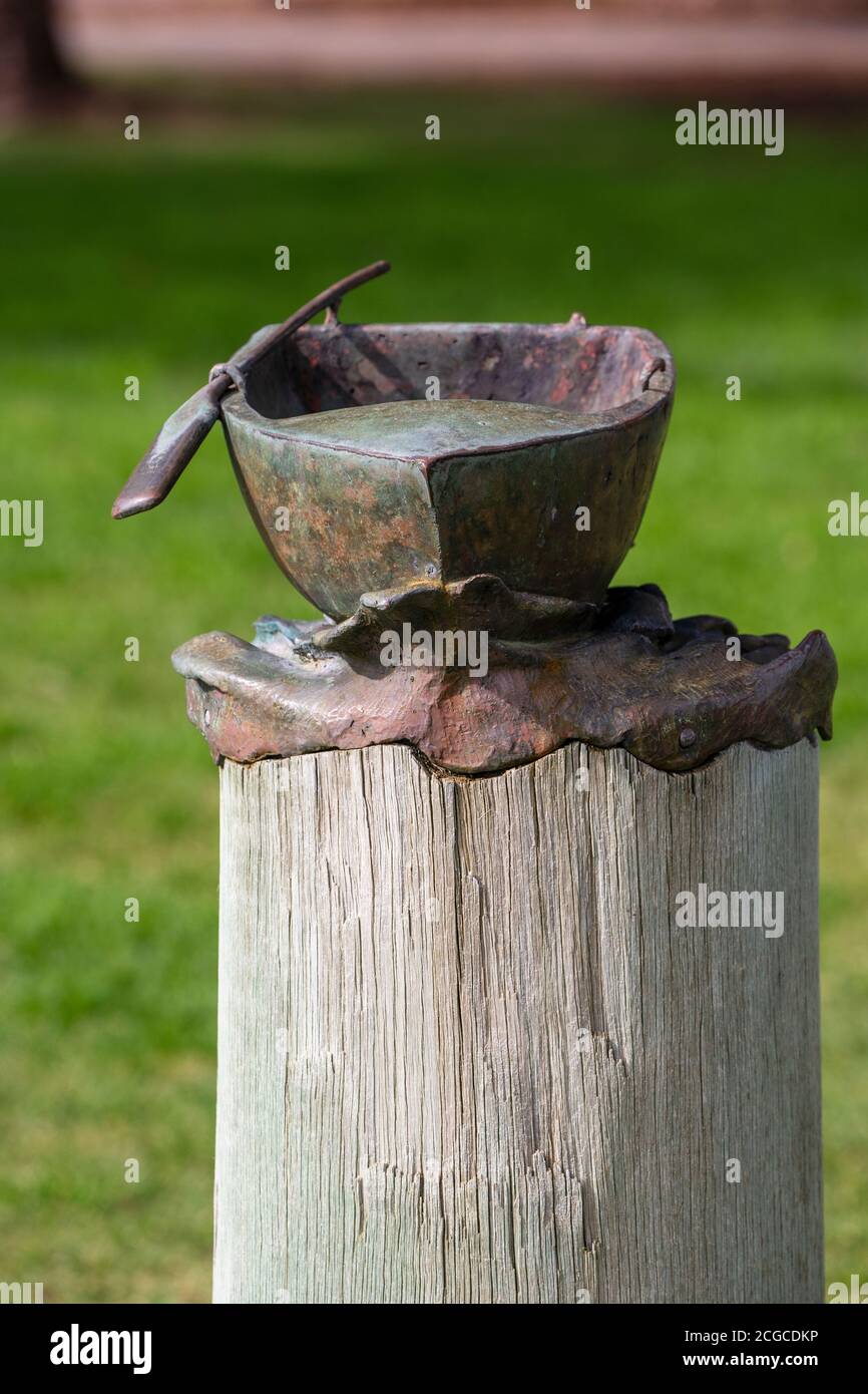 Mandurah, Western Australia - August, 2020: Bronze sculpture of a boat with paddle at Mandurah artwalk. The sculpture is a part of public artwork Thre Stock Photo