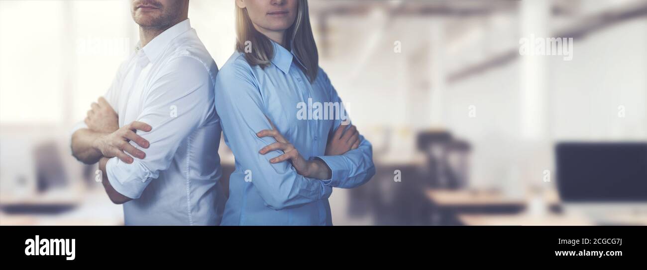 young business people couple posing with arms crossed on office background. copy space Stock Photo