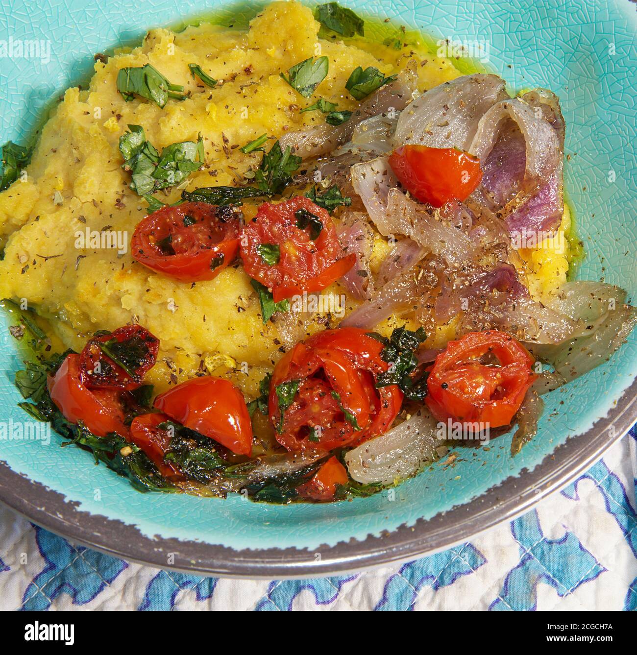 Greek Fava.Yellow split pea puree with cherry tomatoes and caramelized onions ,garnished with parsley. Mediterranean traditional meal. Stock Image. Stock Photo