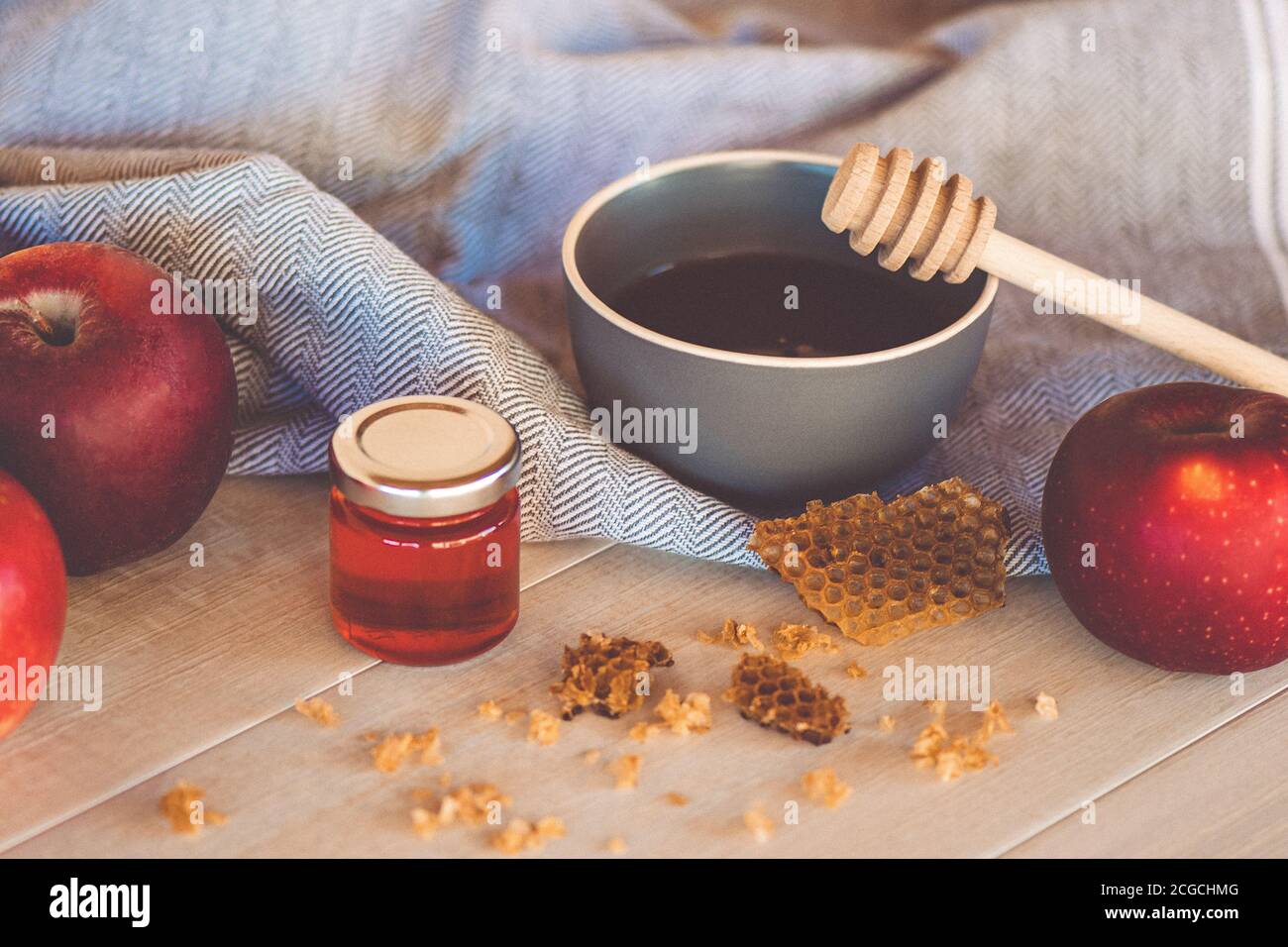 Jewish National Holiday. Rosh Hashana with honey, apple and pomegranate on wooden table. Stock Photo
