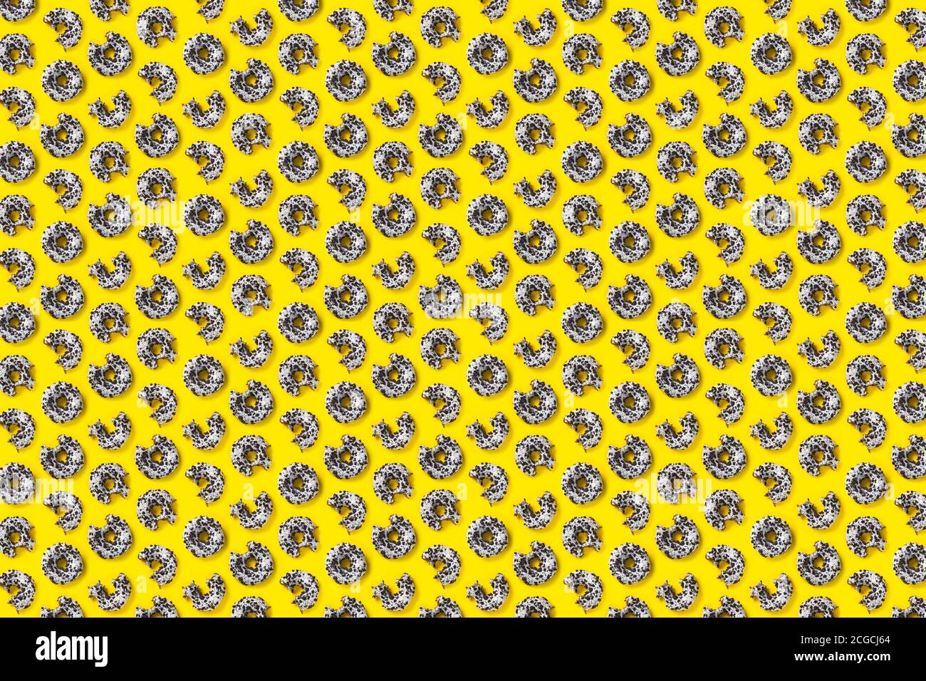 donuts on a yellow background top view. Flat lay of delicious nibbled ...