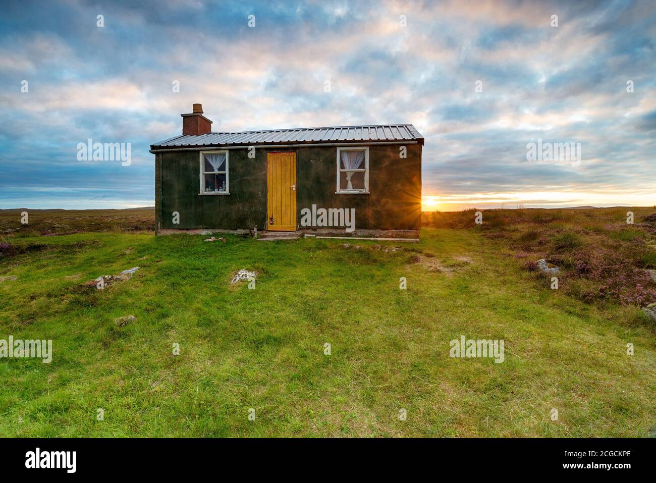 Sunset over a shieling hut on Pentland Road near Stornoway on the Ilse of Lewis in the Western Isles of Scotland Stock Photo