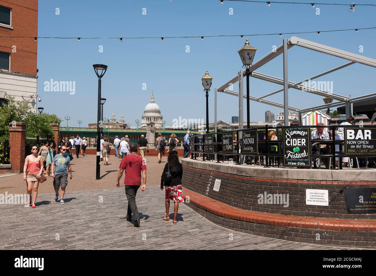 Tourists walking along the South Bank of the River Thames in London, England. Stock Photo