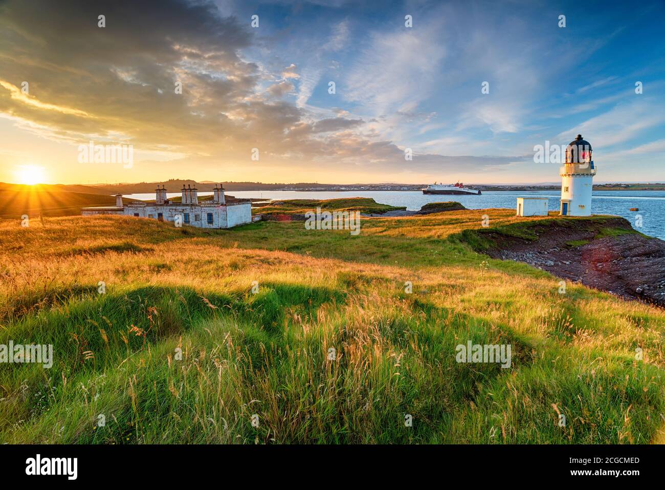 Stunning sunset over Arnish Point and it's lighthouse overlooking Stornoway harbour on the Isle of Lewis in the Outer Hebrides of Scotland Stock Photo