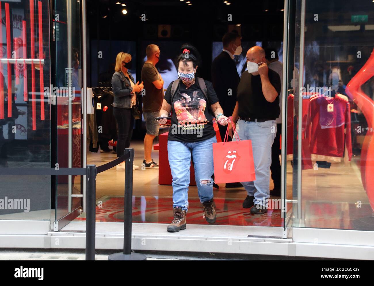 London, UK. 09th Sep, 2020. A shopper wearing a facemask departs the new Rolling Stones store with her purchases inside a Rolling Stones logo bag.The official Rolling Stones store, RS No. 9 opens in London's Carnaby Street. Credit: SOPA Images Limited/Alamy Live News Stock Photo